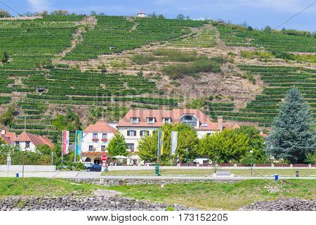 KREMS AUSTRIA - 28TH AUGUST 2015: Buildings along the waterfront in Krems. Wineries can be seen.