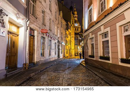 RIGA LATVIA - 1ST JAN 2017: A view along streets in Riga towards the Riga Dome Cathedral at night.