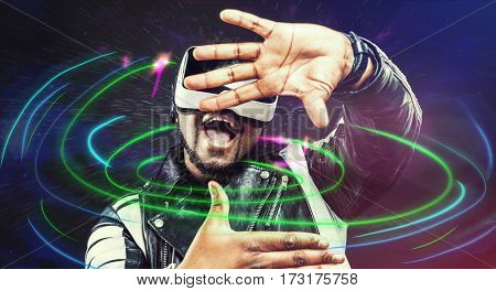Young man wearing virtual reality VR glasses / googles.