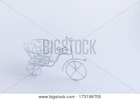 Small decorative white bicycle on a white background. Background mode