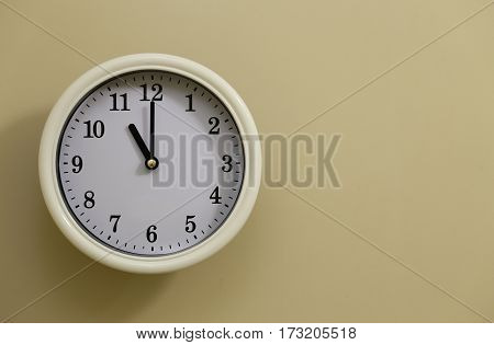 The time for wall clock of the wall is 11:00