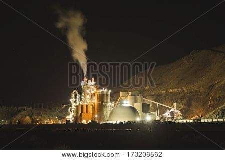 Concrete plant in desert landscape at night.