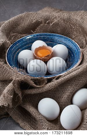 Ecological natural fresh eggs collected in the plate for cooking on the fabric.