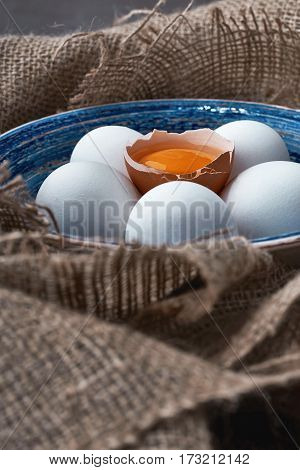 Ecological natural fresh eggs collected in the plate for cooking on the fabric.