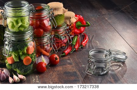 Jars With Marinated Food And Organic Raw Vegetables