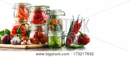 Jars With Marinated Food And Raw Vegetables Isolated On White