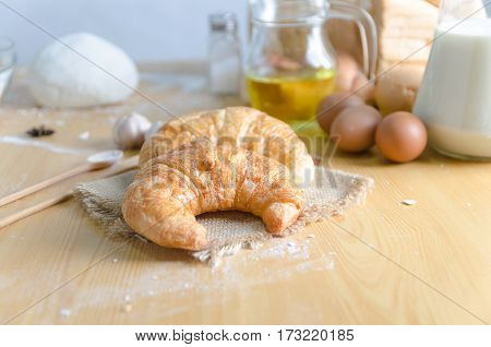 Close up shot of Croissant and bekery ingredients on wooden table