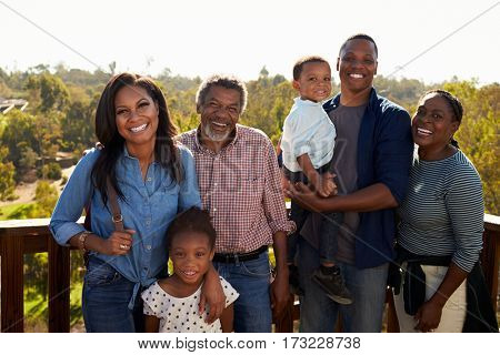 Multi Generation Family Standing On Outdoor Observation Deck