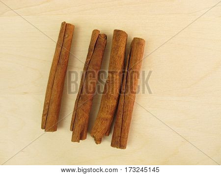 Dried chinese cassia bark sticks on wooden board