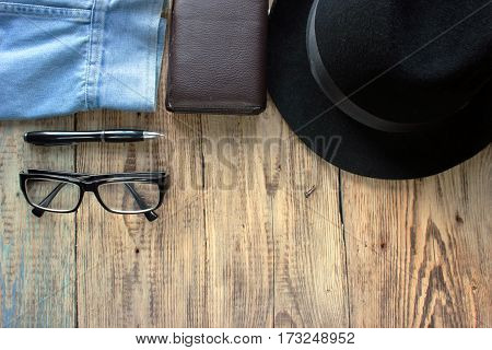 Overhead view of men's casual outfits Outfits of traveler  male Men's casual outfits on wood board background