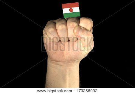 Man Hand Fist With Nigerien Flag Isolated On Black Background