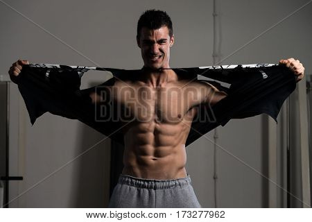 Man Riping The T-shirt Off In Gym