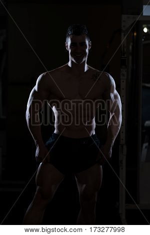 Silhouette Man Standing Strong In Gym