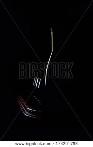 Elegant wine glass and a wine bottles in black background reflection