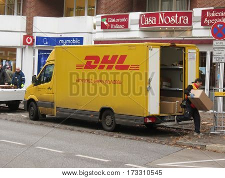 HAMBURG GERMANY - CIRCA NOVEMBER 2016: DHL Deutsche post van parked in a street of the city centre for delivery. DHL is one of the leading private mail companies in Europe.
