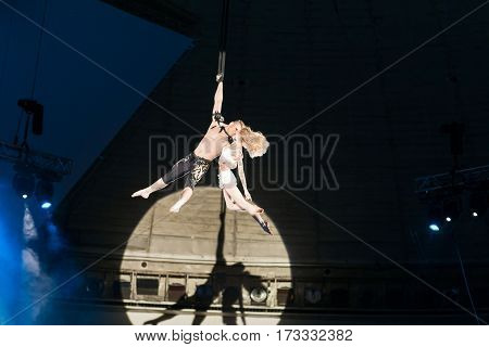 Stunt aerialists men and women in the circus. Love, danger, and romance concept.