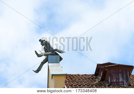 KLAIPEDA LITHUANIA - JULY 11 2015: Monument to chimneysweep on roof Klaipeda Lithuania