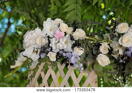 Beautiful trellis, decorated with tenderless bouquet, outdoor