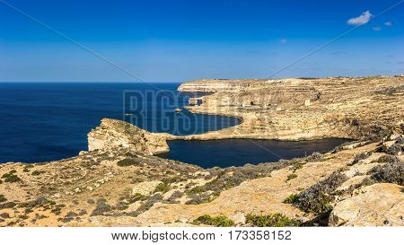Gozo Malta - Panoramic view of the famous Azure Window with the Fungus rock and Dwejra bay on a beautiful summer day with clear blue sky