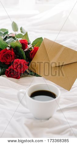 a bouquet of red roses coffee card with congratulations supply in bed