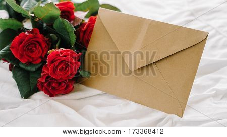 a bouquet of red roses coffee card with congratulations supply in bed