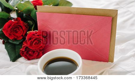 a bouquet of red roses coffee card with congratulations supply in bed