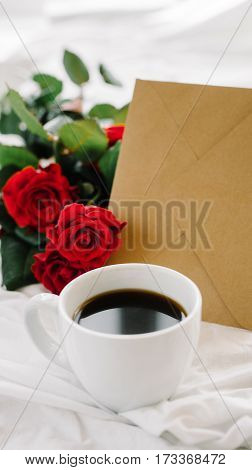 a bouquet of red roses coffee card with congratulations supply in bed
