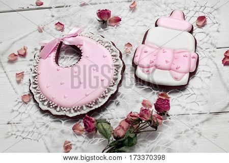 Cookies With Glaze In The Form Of Arcin And Bottle Milk With Petals Of Dried Rosses . On White Woode