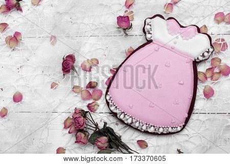 Cookies With Glaze In The Form Of Dress With Petals Of Dried Roses. On White Wooden Surface.