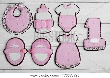 Cookies With Glaze In The Form Of Dress,baby Body,shoes,bottle Milk With . On White Wooden Surface.