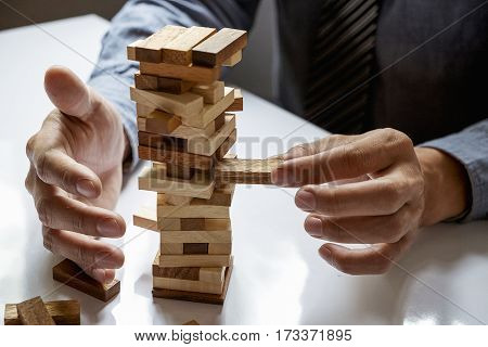 A Male Hand Stopping The Domino Effect. Retro Style Image Executive And Risk Control Concept