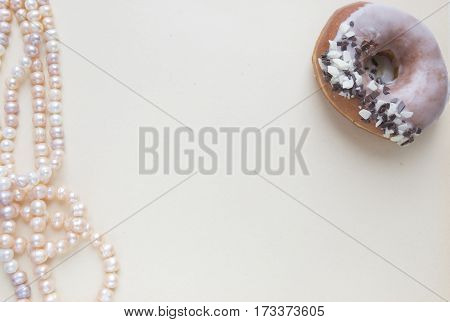 Blank craft background. Sheet of rough paper with rose pearls and donut. Mock up for letter writing, creative work concept.