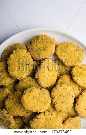 Tasty North Indian snack mathri or mathari served with pickle. Selective focus photograph.