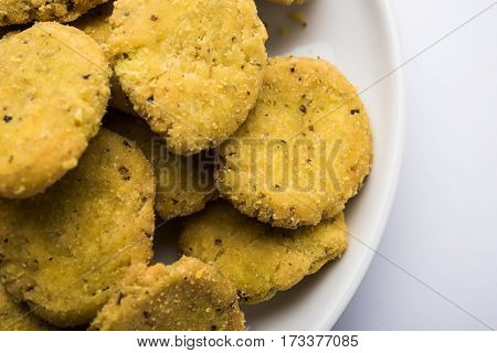 Tasty North Indian snack mathri or mathari served with pickle. Selective focus photograph.