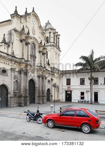 red car near catholic church inwhite city popayan colombia south america