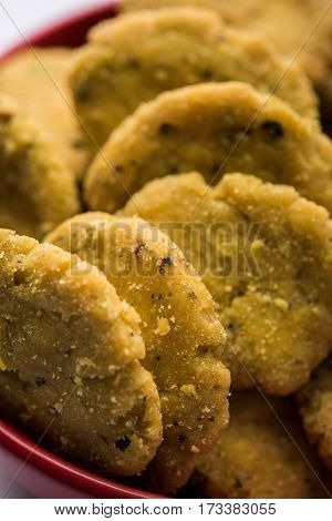 Tasty North Indian snack mathri or mathari served with pickle. Selective focus photograph.