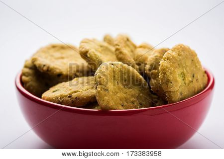 Tasty North Indian snack mathri or mathari served with pickle. Selective focus photograph.