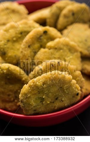 Tasty North Indian snack mathri or mathari served with pickle. Selective focus photograph.