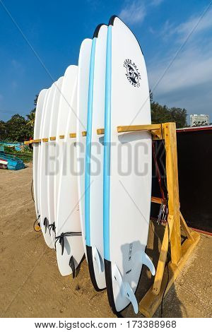 WELIGAMA SRI LANKA - JANUARY 12 2017: Set of different color surf boards in a stack by ocean.WELIGAMA SRI LANKA. Surf boards on sandy Weligama beach. On Weligama beach surf is available all year around for beginner and advanced.