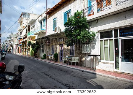 SITIA, CRETE, GREECE - JUNE 2016: Street of Sitia town with shops and bars on Crete island, Greece