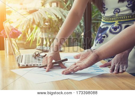 The above view of business meeting dicuss financial data vintage tone