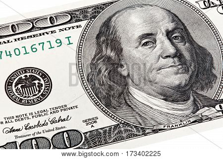 Stack shot of Benjamin Franklin portrait from a $100 bill.