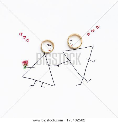 Wedding rings in the picture with the bride and groom painted by bride at her wedding day.