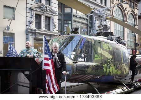 NEW YORK - NOV 11, 2016: Steve Maloney and his mixed-media sculpture Take Me Home Huey, a restored US Army Huey air ambulance helicopter from the Vietnam War in the Americas Parade on Veterans Day.