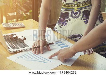 The above view of business meeting dicuss financial data vintage tone