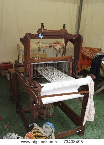 Antique vintage spinner machine working . Tuscany, Italy