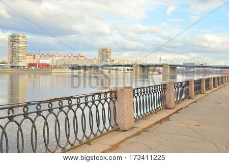 Volodarsky Bridge and fence on the embankment of the Neva River in St.Petersburg at cloud spring day Russia.