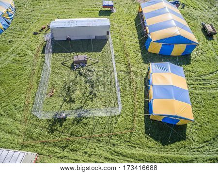 Aerial view of a circus tent with cage of white tigers