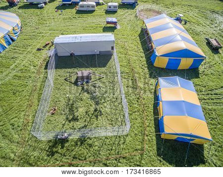 Aerial view of a circus tent with cage of white tigers