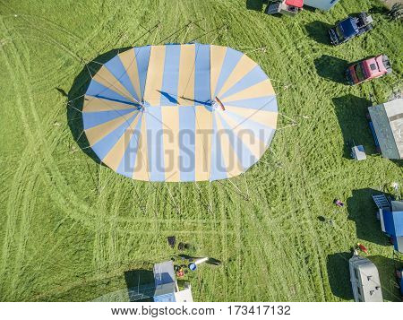 Aerial view of a circus tent with cage of white tigers